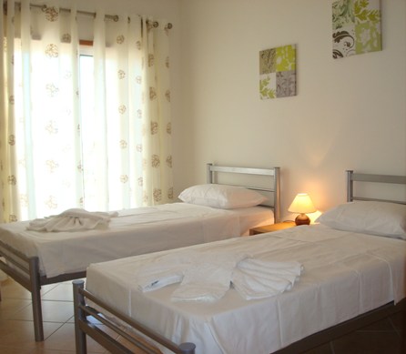 Spacious double bedroom with twin beds and wardrobes