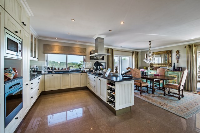 Spacious open plan design kitchen with cooking island and high quality kitchen equipment
