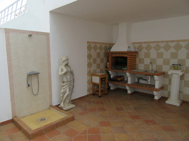 Semi covered terrace with fitted BBQ, summer kitchen, table & chairs and outside shower 