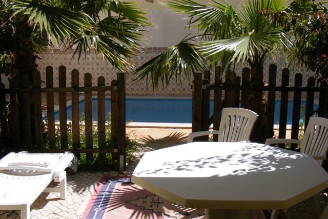 Private patio area with table & chairs, access to swimming pool